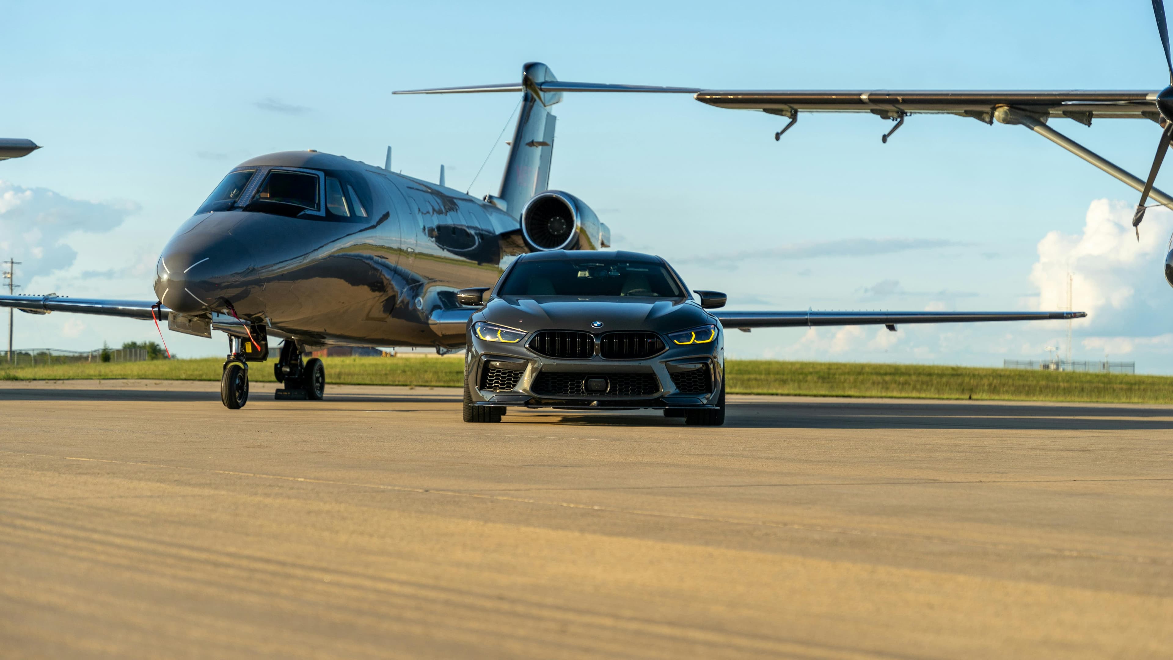 Luxury ground transport staged at a private jet terminal.